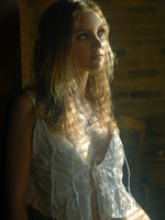 blonde in frilly white under cloths and soft lights.
